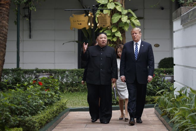 President Donald Trump and North Korean leader Kim Jong Un take a walk at the Sofitel Legend Metropole Hanoi hotel, Thursday, Feb. 28, 2019, in Hanoi. (AP Photo/ Evan Vucci)