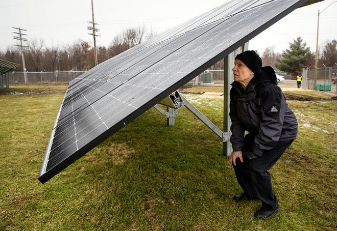 Bob Ducker, a Sierra Club supporter, inspects the electrical components under the solar panels of the city of Springfield's newly completed solar farm before its official unveiling Thursday, Dec. 13, 2018. [Ted Schurter/The State Journal-Register]