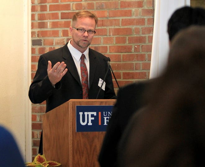 Kevin Folta, a horticultural sciences faculty member at the University of Florida, welcomes guests to a dinner at the President's Mansion on the UF campus in March 2014. [Brad McClenny/Staff photographer]
