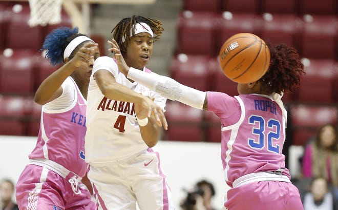 Alabama guard Cierra Johnson (4) passes out of a trap by Kentucky forward Keke McKinney (3) and Kentucky guard Jaida Roper (32) as the Crimson Tide hosted the Wildcats on Power of Pink Night Monday, Feb. 11, 2019 in Coleman Coliseum. [Staff Photo/Gary Cosby Jr.]