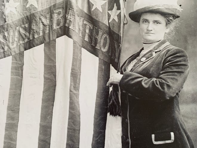 Lucy Anthony, standing next to a patriotic banner honoring her aunt, Susan B. Anthony. [PHOTO COURTESY OF OSTERVILLE HISTORICAL MUSEUM]