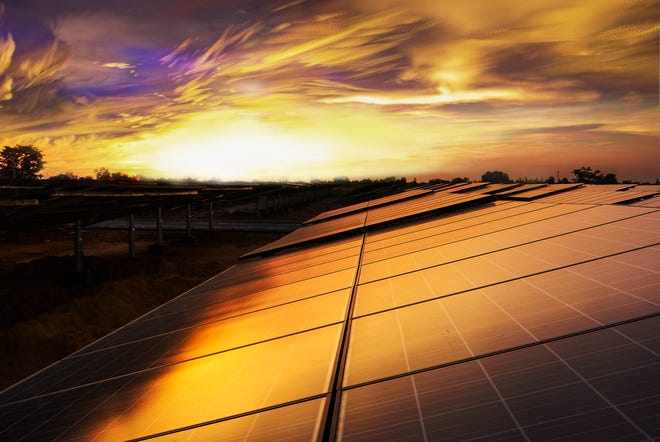 An image of a solar panel highlighted by sunset. 

[Photo courtesy of Getty Images]