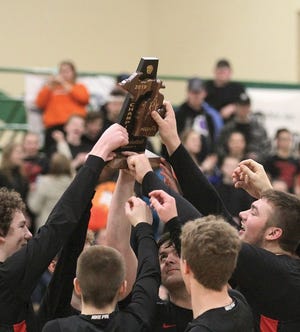 The Howardsville Christian basketball team celebrates a district championship on Friday night in Mendon.