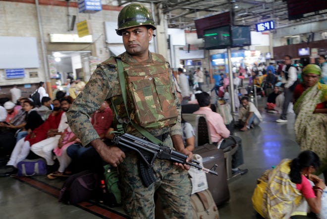 An Indian police officer keeps guard at Chhatrapati Shivaji Terminus railway station in Mumbai, India, Thursday, Feb. 28, 2019. Pakistan's prime minister pledged on Thursday his country would release a captured Indian jetfighter pilot the following day, a move that could help defuse the most-serious confrontation in two decades between the nuclear-armed neighbors over the disputed region of Kashmir. An Indian government official, speaking on condition of anonymity as he was not authorized to speak publicly, warned that even if the pilot is returned home, New Delhi would not hesitate to strike its neighbor first if it feared a similar militant attack was looming. (AP Photo/Rajanish Kakade)