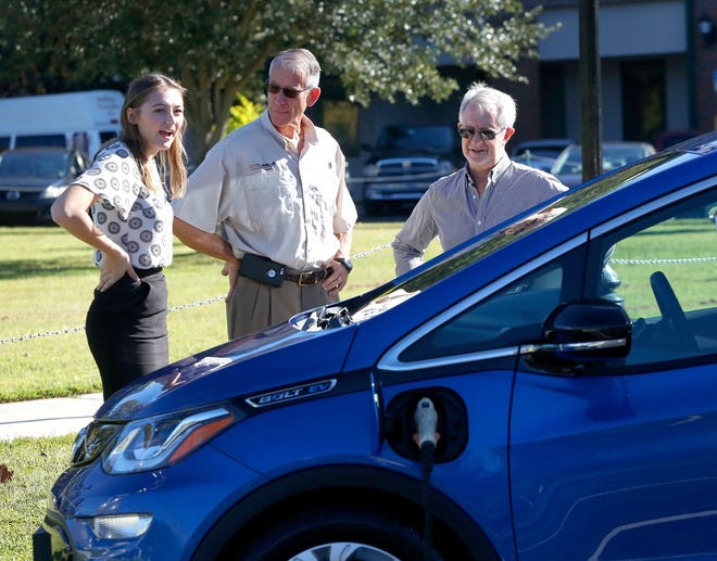 An electric Chevy Bolt is connected to a charging station in Magnolia Park in Gainesville during a program to promote federal clean energy standards. [The Gainesville Sun, File]