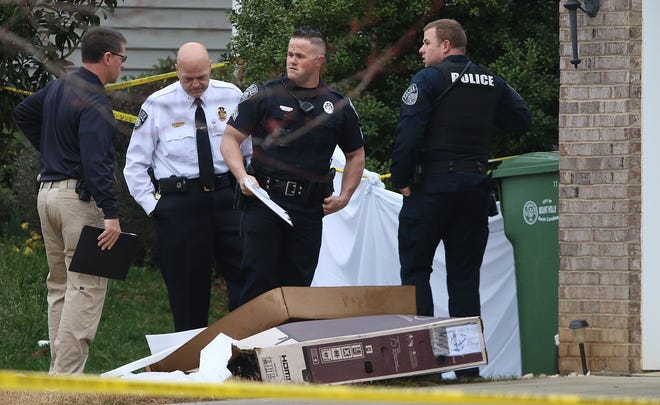 Mount Holly Police, including Chief Don Roper in white shirt, look over the scene of a fatal officer-involved shooting outside a home on Barrington Drive in Mount Holly early Saturday morning, March 2, 2019. [Mike Hensdill/The Gaston Gazette]