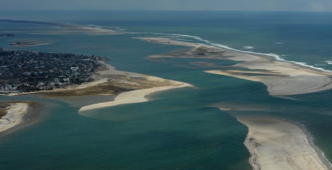 A 2018 photo shows the 1987 Chatham Break, lower right, that was the main entrance to Chatham Harbor for the fishing fleet and other boaters until nor'easters in 2007 produced the North Cut (top third of the photo) that is now commonly used to get out to the Atlantic. North Beach Island, also known as Middle Beach, lies between the two inlets and geologists fear it could disappear in the coming years, increasing erosion on the mainland. [Steve Heaslip/Cape Cod Times]