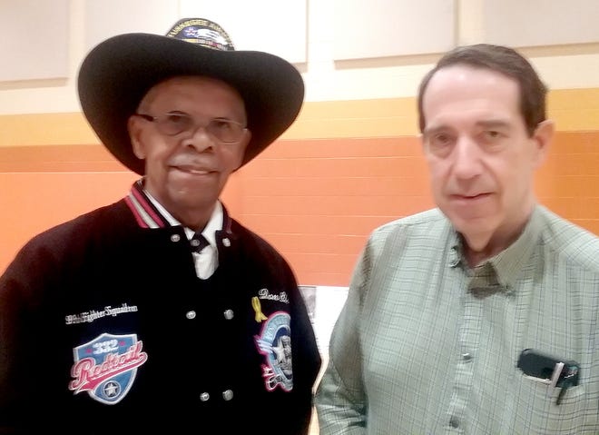 Rick Booth, r, of Cambridge, met with Don Elder, a member of the Tuskogee Airmen, at the presentation of "The Flying Hobos" in Columbus recently.