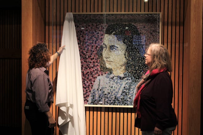 Bristol’s Department Chair of Visual and Performing Arts Marisa Millard and the college’s fine arts students unveil a portrait of Holocaust victim Anne Frank made from thousands of garment buttons. The artwork is displayed in the lobby of the Jackson Arts Center, on the Bristol Fall River campus. [Submitted Photo]