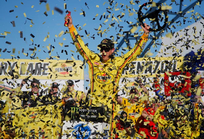 Joey Logano celebrates his win at Las Vegas Motor Speedway on Sunday. [John Locher/The Associated Press]