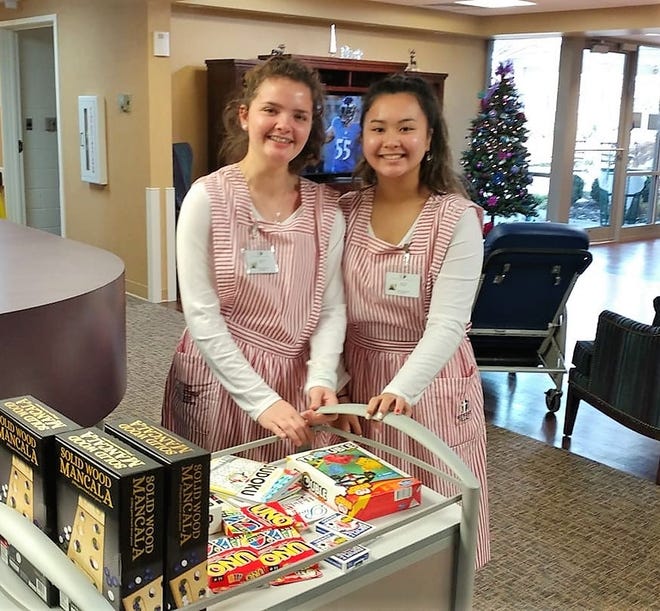 Lennon Wise, left, and Nhi haTran volunteer as candy stripers at Methodist Village Senior Living in Fort Smith. [Photo courtesy Methodist Village]
