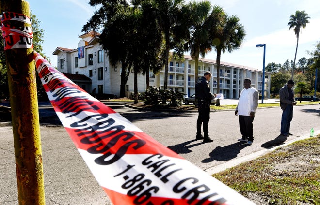 The Jacksonville Sheriff's Office investigate a police involved fatal shooting in the parking lot of the Motel 6 off Dunn Avenue Wednesday morning, December 12. 2018. [Bob Self/Florida Times-Union]