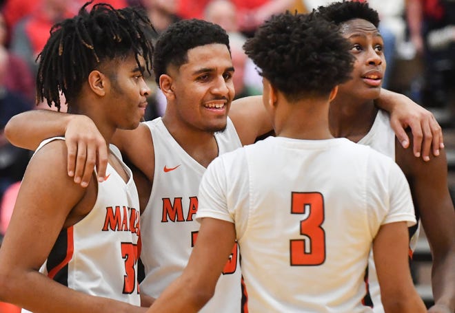 RON JOHNSON/JOURNAL STAR Manual players celebrate their 45-36 win over Metamora in the Class 3A East Peoria regional championship game.