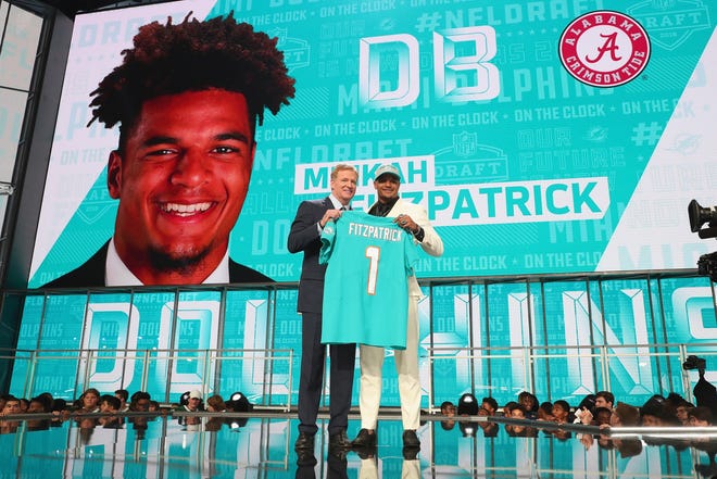 Minkah Fitzpatrick poses with NFL Commissioner Roger Goodell after being picked #11 overall by the Miami Dolphins during the first round of the 2018 NFL Draft [TOM PENNINGTON/GETTY]
