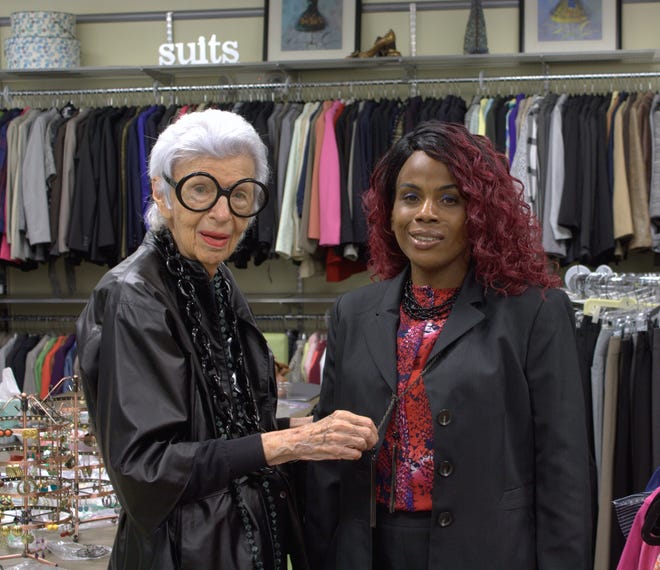 Iris Apfel helps local client Patipa Brown accessorize her outfit at the Lantana office of Dress for Success Palm Beaches, which provides clothing and business advice for women entering the work world. [Photo courtesy of Dress for Success Palm Beaches]