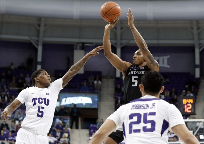 Kansas State guard Barry Brown shoots over TCU's Kendric Davis, left, and Alex Robinson during Monday's game in Fort Worth, Texas. The No. 18-ranked Wildcats won 64-52 and are one victory away from clinching at least a share of the Big 12 championship. [Tony Gutierrez/The Associated Press]