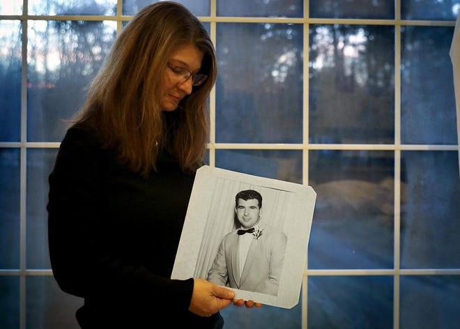 Deborah Chalak looks at a portrait of her late father David Berman from his wedding day at her home in Upton on Thursday, Jan. 10, 2019. Chalak was raised in the home her father lived in until the day he died tragically in a fire at that same home.[Alyssa Stone/The Enterprise]