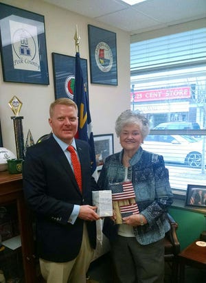 Pictured is Brett Keeter from Congressman McHenry's office presenting flags to Alice Dention. The flags were given to first graders at Springfield Elementary School in Stanley during a program on Feb. 28. [PHOTO COURTESY OF CHARLENE HIGH]