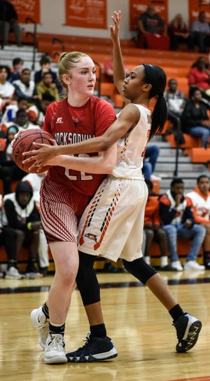 Jacksonville's Kelly Luck, left, fights through Southeast Guilford's Sydney Roberts during Tuesday night in the NCHSAA 3-A East Regional semifinal. [Jay Capers/Special to The Daily News]