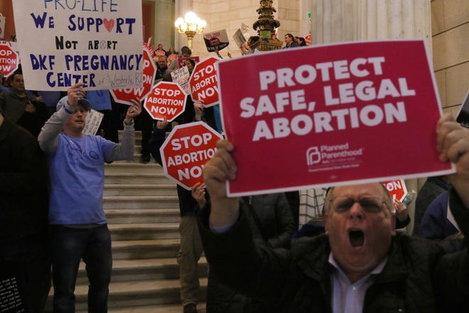 Emotions run high on both sides in the State House rotunda outside the House Judiciary Committee's hearing on a proposal to guarantee the legality of abortion in Rhode Island. The vote to approve was 9 to 7, and the bill is now scheduled for a vote by the full House on Thursday. [The Providence Journal / Bob Breidenbach]