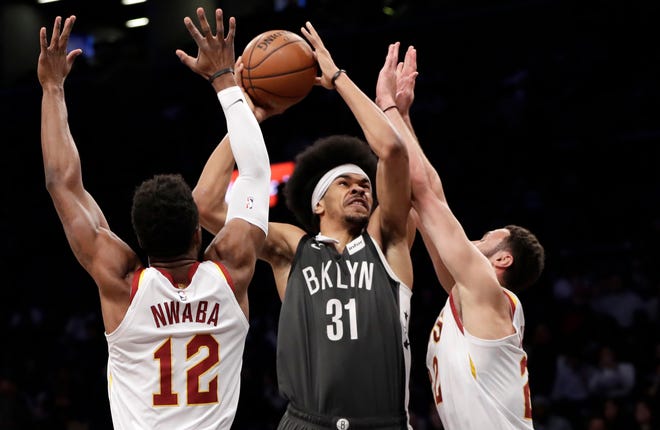 Cleveland Cavaliers guard David Nwaba (12) and forward Larry Nance Jr. (22) defend against Brooklyn Nets center Jarrett Allen (31) during the first half of an NBA basketball game Wednesday, March 6, 2019, in New York.