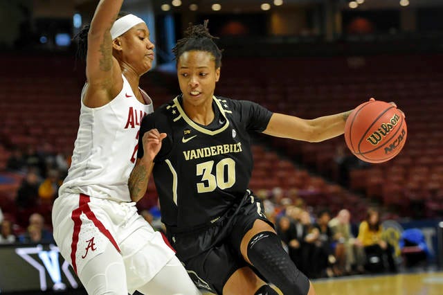 LeaLea Carter (30) drives against Alabama’s Shaquerra Wade during Wedneday’s SEC Tournament matchup. Carter scored a team-high 14 points in the Commodores’ season-ending 74-57 opening-round loss. (Richard Shiro/The Associated Press)