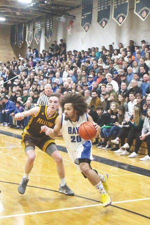 Brimley's Marcus Harris (20) tries to drive past Pellston's Kaleb Rybinski (1) during a Division 4 boys basketball semifinal Tuesday night in St. Ignace.