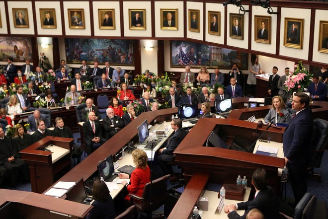 Florida Gov. Ron DeSantis, right, gives the state of the state address on the first day of legislative session Tuesday, March 5, 2019, in Tallahassee, Fla. (AP Photo/Steve Cannon)