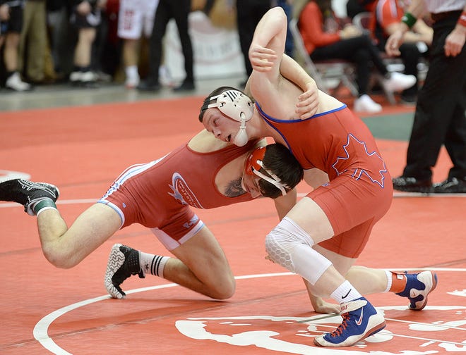 Mapleton's Jeremy Tracy (right) wrestles Lima Central Catholic's Joey Caprella during their 145-pound weight class match on the opening day of the 82nd annual State Wrestling Individual Tournament at Ohio State’s Schottenstein Center on Thursday. Tracy lost to Caprella but bounced back and won his first consolation match.