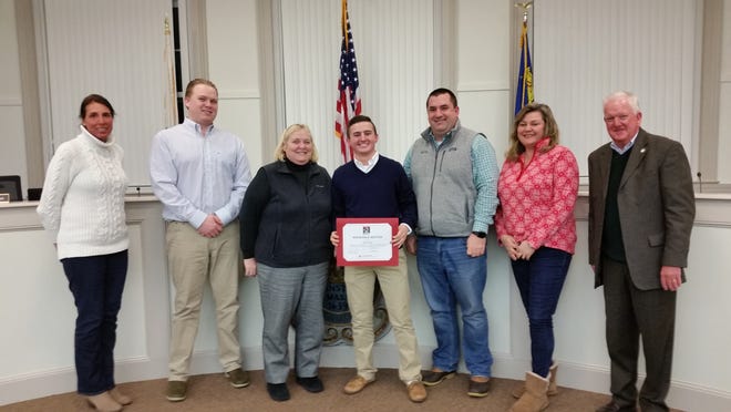 As a Craigville Beach lifeguard, Ethan Sirhal, center, helped save the life of a 17-year-old swimmer at Covell's Beach on July 3, 2018. The Barnstable Recreation Commission surprised Sirhal on March 4 with an Honorable Mention "Hero of the Year Award" from the American Red Cross Cape & Islands and Southeastern Massachusetts. "That young lady would not be walking this earth if you hadn't done CPR on her," said Barnstable Recreation Director Patti Machado. [COURTESY PHOTO]