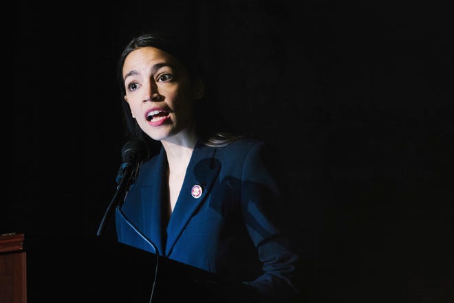 Rep. Alexandria Ocasio-Cortez, D-N.Y., delivers her inaugural address following her swearing-in ceremony at the Renaissance School for Musical Theater and Technology in the Bronx borough of New York on Saturday, Feb. 16, 2019. (AP Photo/Kevin Hagen)