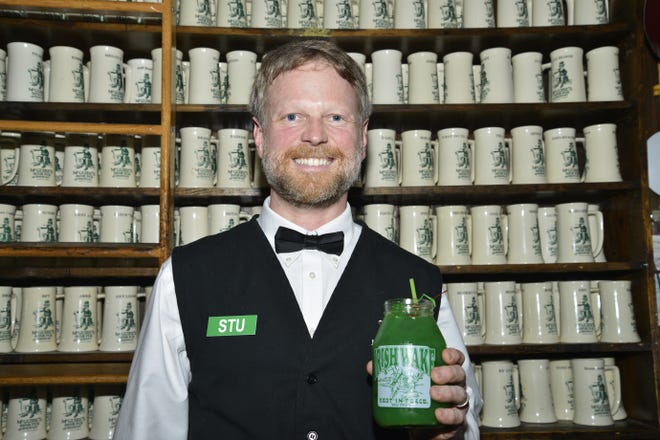 Stu Campbell of McGuire's Irish Pub in Destin said he loves bartending because it's like catching up with friends all day long. [SAVANNAH VASQUEZ/DAILY NEWS]