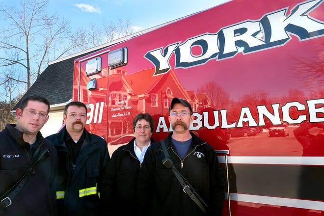 York Village firefighter Jon Gay, left, joins York Ambulance Deputy Assistant Chief Joshua Allen, Ambulance Chief Karen Tucker and York Beach Capt. Dave Osgood Thursday, where the new York Ambulance was dedicated to Berwick Fire Capt. Joel Barnes, who worked for York Ambulance. Capt. Barnes, 32, lost his life March 1, while battling a four-alarm fire at an apartment building at 10 Bell St. in Berwick.

[Rich Beauchesne/Seacoastonline]