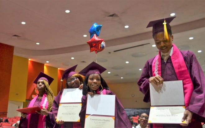From left to right, Skie Langston, Salena Jones, Destiney Adams, and Camarii Ware celebrate their graduation from Petersburg High School and the Challenge U program. Jacoby Dewitt, not pictured, was another one of the graduates. [Lindsey Lanham/progress-index.com]