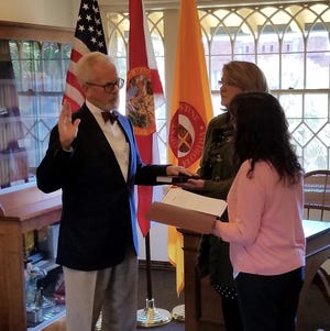 Tracy Upchurch, left, officially became St. Augustine’s mayor Thursday when he took the oath of office administered by City Clerk Darlene Galambos. Upchurch will take the oath again in a brief ceremony in a more formal setting on Monday just prior to the City Commission’s regular meeting. [CONTRIBUTED]