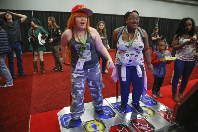 Elizabeth Prudente and Illya Maxwell play "Pump It Up Exceed" during SXSW Gaming 2018. This year's SXSW Gaming will run from Friday through Sunday, unlike previous years. 

[JAMES GREGG/AMERICAN-STATESMAN]