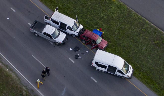 Officials investigate near a red vehicle that was driven by Austin bomber Mark Conditt on Interstate 35 in Round Rock on March 21. [JAY JANNER / AMERICAN-STATESMAN]
