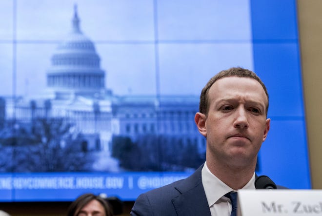FILE - In this April 11, 2018, file photo, Facebook CEO Mark Zuckerberg pauses while testifying before a House Energy and Commerce hearing on Capitol Hill in Washington about the use of Facebook data to target American voters in the 2016 election and data privacy. Zuckerberg said Facebook will start to emphasize new privacy-shielding messaging services, a shift apparently intended to blunt both criticism of the company's data handling and potential antitrust action. (AP Photo/Andrew Harnik, File)