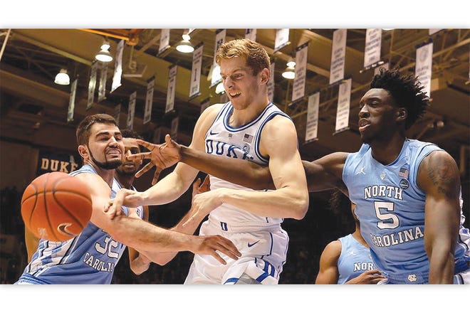 RIVALRY RENEWED — Duke’s Jack White battles UNC’s Luke Maye (32) and Nassir Little (5) for the ball in the
first UNC-Duke meeting of the season on Feb. 20 in Durham.