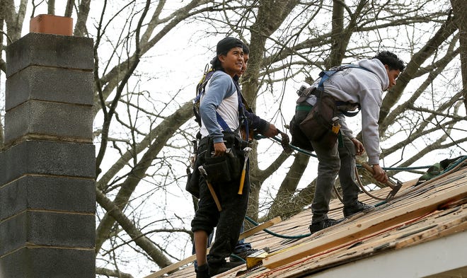 A crew from Southern Star Roofing is installing a new roof on Wade and Louise Lunsford's Westview Street home in Gastonia. [JOHN CLARK/THE GASTON GAZETTE]