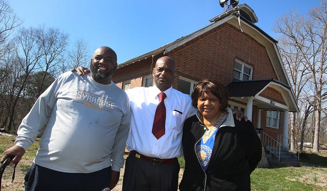Deacon Malcolm Long, Bishop Randy Smith and trustee Sandra Davis pose together outside the future location of Greater Hopewell Full Gospel Church on Smyre Drive on Thursday afternoon, March 7, 2019. [Mike Hensdill/The Gaston Gazette]