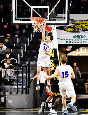 Sophomore Joe Berry (11), who led Washburn Rural with 14 points, dunks the ball during Friday's 6A semifinals at Koch Arena. [KellyRoss/GateHouse Kansas].