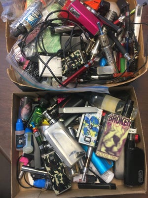 Here are two boxes worth of vaping items confiscated from students at Canandaigua Academy. [Megan French for Messenger Post Media]