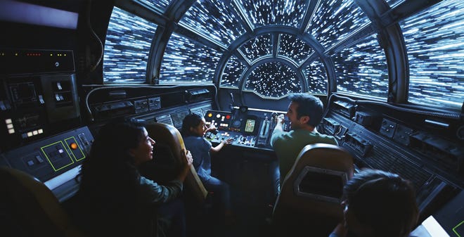 This rendering released by Disney and Lucasfilm shows people on the planned Inside Millennium Falcon: Smugglers Run attraction, part of Star Wars: Galaxy's Edge, a 14-acre area set to open this summer at the Disneyland Resort in Anaheim, California, then in the fall at Disney's Hollywood Studios in Orlando, Florida. (Disney Parks/Lucasfilm via AP)