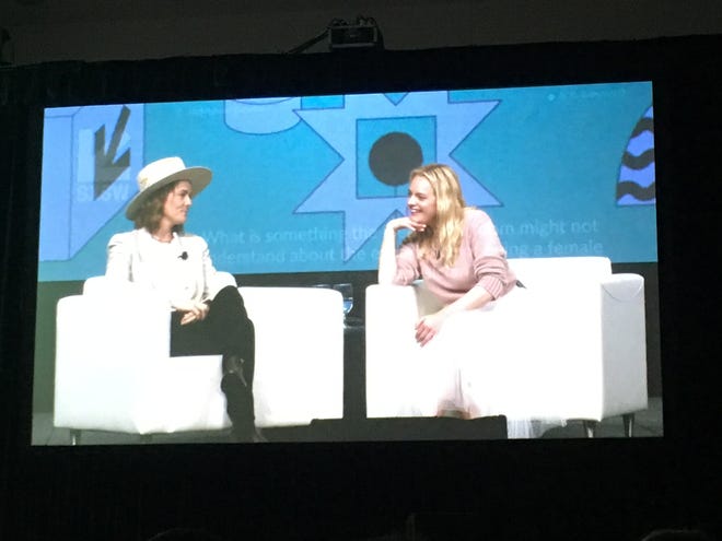 A video screen in the Austin Convention Center shows singer-songwriter Brandi Carlile and actress Elisabeth Moss in conversation at South by Southwest on Sunday, March 10, 2019. [Peter Blackstock / American-Statesman]