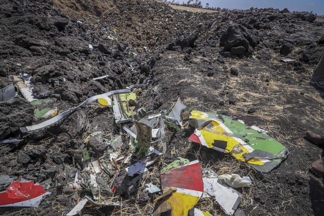 Wreckage lies at the scene of an Ethiopian Airlines flight that crashed shortly after takeoff at Hejere near Bishoftu, or Debre Zeit, some 50 kilometers (31 miles) south of Addis Ababa, in Ethiopia Sunday. The Ethiopian Airlines flight crashed shortly after takeoff from Ethiopia's capital on Sunday morning, killing all 157 on board, authorities said, as grieving families rushed to airports in Addis Ababa and the destination, Nairobi. [AP Photo]