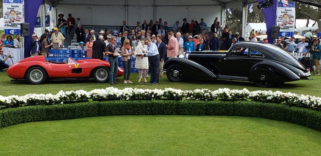 Arturo Keller (center) sprays champagne in between his 1938 Mercedes-Benz 540K Special Autobahn Courier (right), which won Best of Show Concours d'Elegance, and Brian and Kim Ross' 1957 Ferrari 335S, which got Best of Show Concour d'Sport, for race cars. [Dan Scanlan/Florida Times-Union]