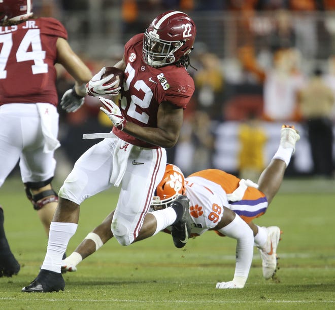 Alabama running back Najee Harris (22) breaks a tackle by Clemson defensive end Clelin Ferrell (99) as he runs in Levi's Stadium in Santa Clara, California, on Monday, Jan. 7, 2019, during the College Football Playoff National Championship game. [Staff Photo/Gary Cosby Jr.]