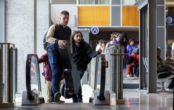 Samuel Mosching, left, and Mitchell Settecase, members of the band Subhi from Chicago, arrive at Austin-Bergstrom International Airport Tuesday, March 12, 2019. [Stephen Spillman for Statesman]