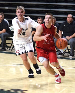 Andy Miller of Hiland drives past Coal Grove's Payton Smith for an easy bucket during Div. IV Regional action at Ohio University Tuesday night. Miller scored seven points in the top-ranked Hawks' 70-39 rout.